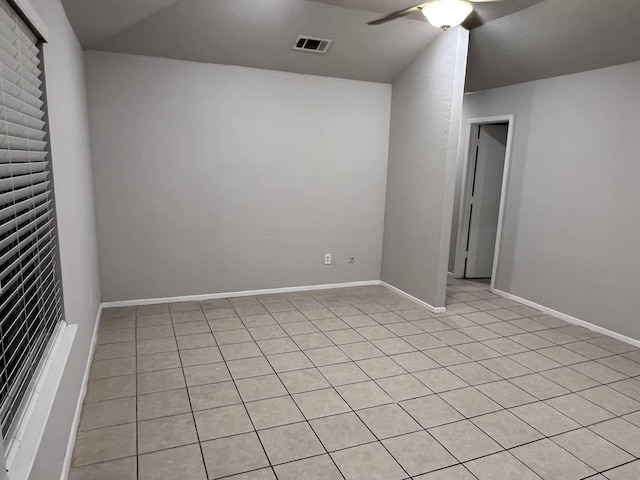 tiled empty room featuring ceiling fan