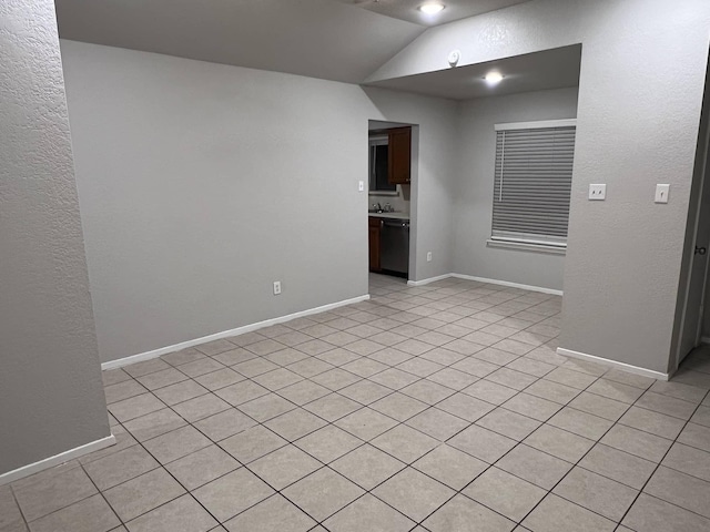 empty room featuring vaulted ceiling