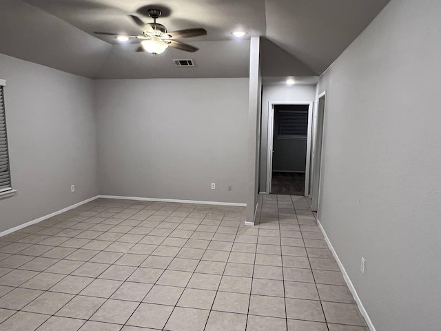 empty room with ceiling fan, light tile patterned flooring, and lofted ceiling