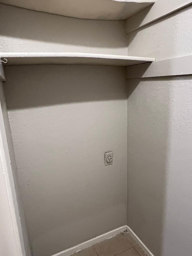 laundry area with electric dryer hookup and tile patterned floors