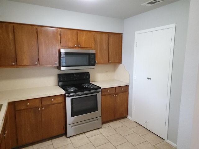 kitchen featuring light tile patterned floors and appliances with stainless steel finishes