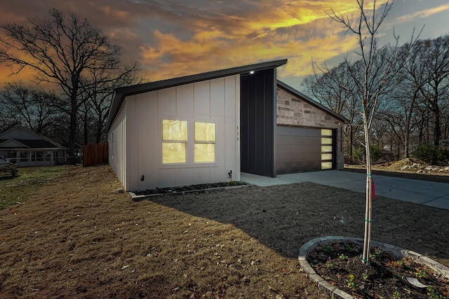 property exterior at dusk with an outbuilding and a garage