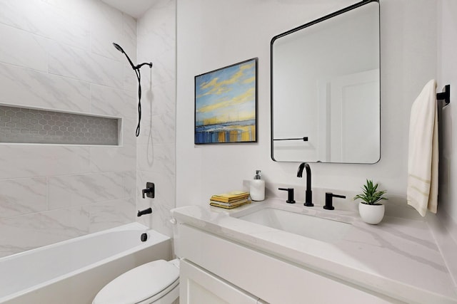 full bathroom with vanity, tiled shower / bath combo, and toilet