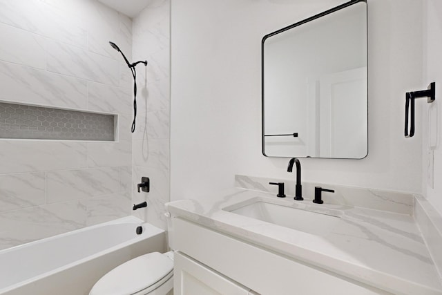 full bathroom with vanity, tiled shower / bath combo, and toilet