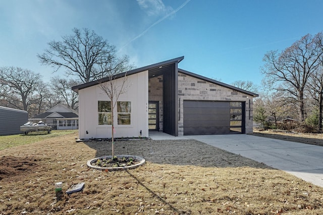 view of front of home featuring a garage and a front lawn