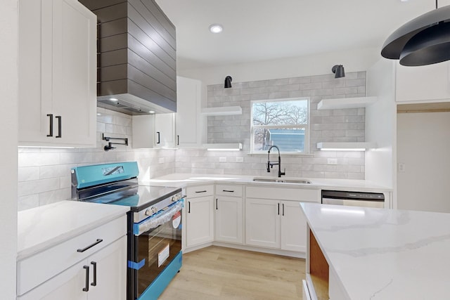 kitchen with decorative backsplash, light stone counters, sink, white cabinets, and black / electric stove