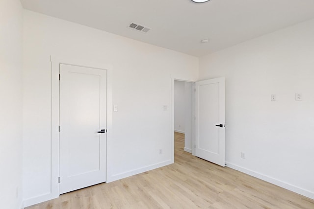 unfurnished bedroom featuring light wood-type flooring