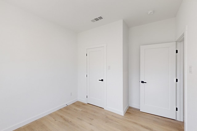 unfurnished bedroom featuring light wood-type flooring