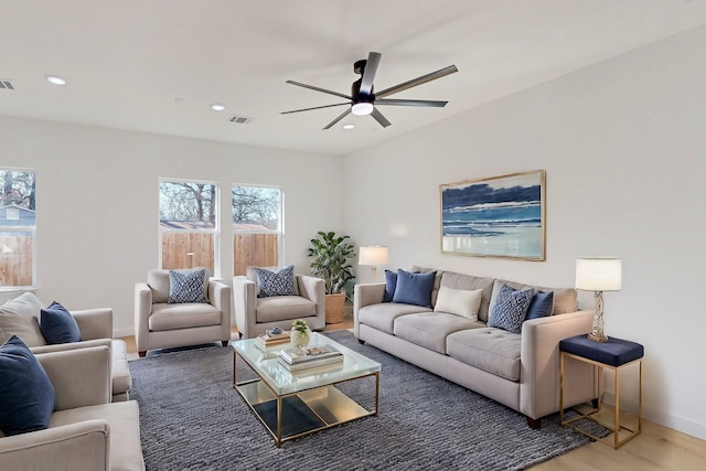 living room with hardwood / wood-style floors and ceiling fan