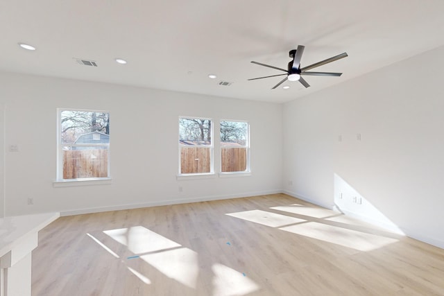 spare room featuring ceiling fan and light hardwood / wood-style flooring