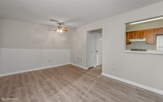 empty room with light hardwood / wood-style flooring and ceiling fan