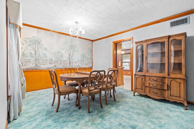 carpeted dining area with ornamental molding and a notable chandelier