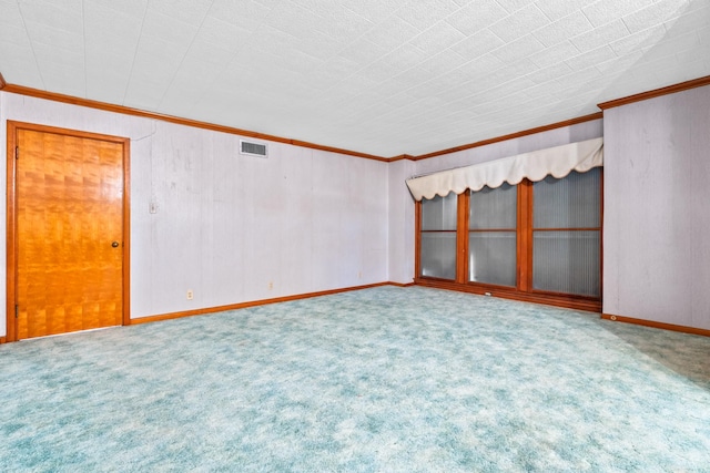 carpeted empty room featuring crown molding