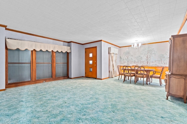 interior space featuring carpet, ornamental molding, and an inviting chandelier