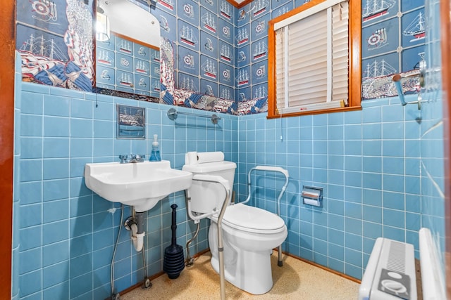 bathroom featuring radiator heating unit, toilet, and tile walls