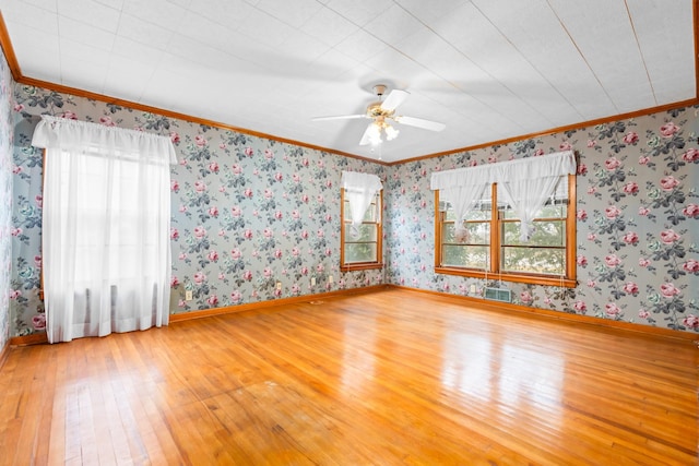 unfurnished room with crown molding, ceiling fan, and wood-type flooring