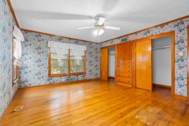 unfurnished bedroom with ceiling fan, ornamental molding, and light hardwood / wood-style flooring