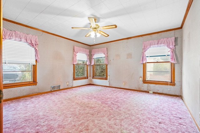 spare room featuring carpet floors, ceiling fan, and crown molding