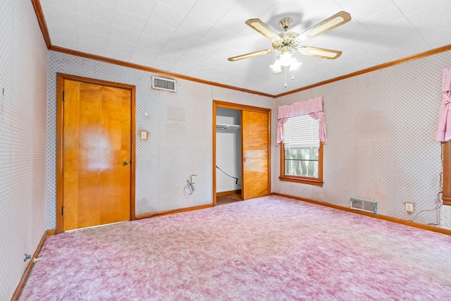 unfurnished bedroom featuring carpet flooring, a closet, ceiling fan, and crown molding