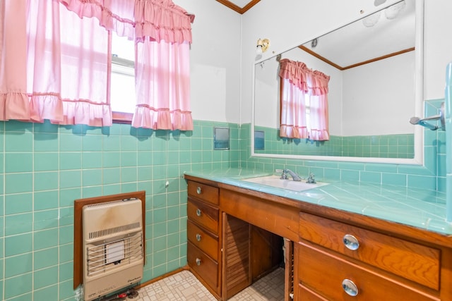 bathroom featuring heating unit, vanity, a healthy amount of sunlight, and tile walls