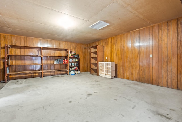 basement featuring wooden walls