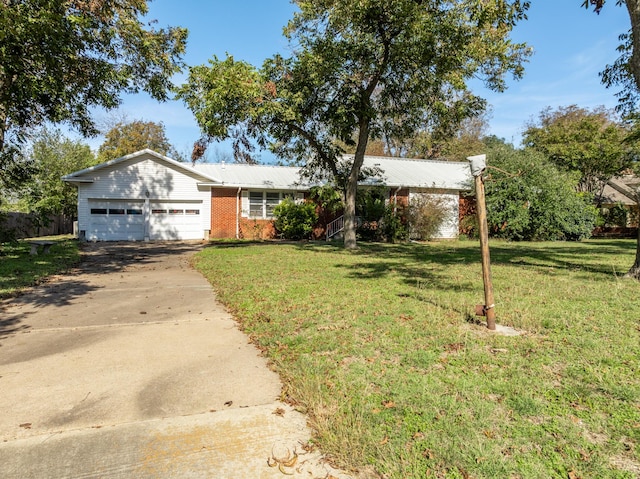 ranch-style home with a garage and a front yard