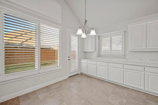 unfurnished dining area featuring light tile patterned floors, lofted ceiling, and an inviting chandelier