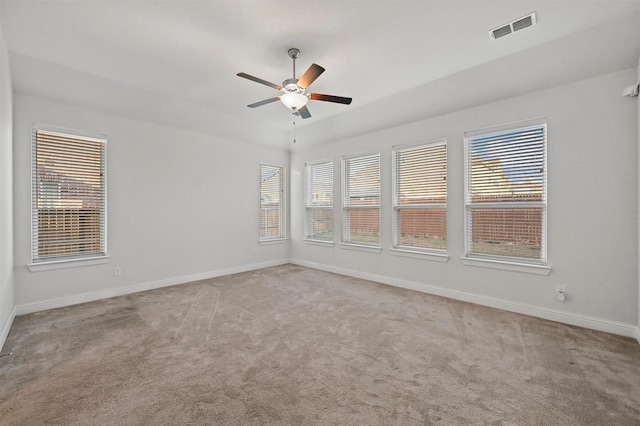 spare room with ceiling fan and light colored carpet