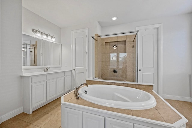 bathroom with tile patterned flooring, vanity, and independent shower and bath