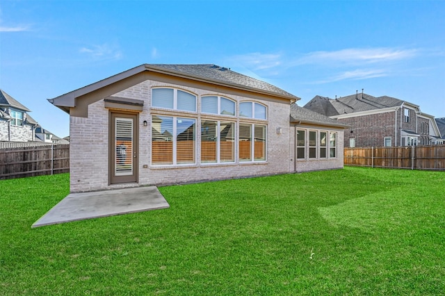 rear view of house with a patio area and a yard