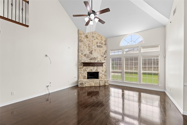 unfurnished living room with high vaulted ceiling, a stone fireplace, ceiling fan, and dark hardwood / wood-style floors