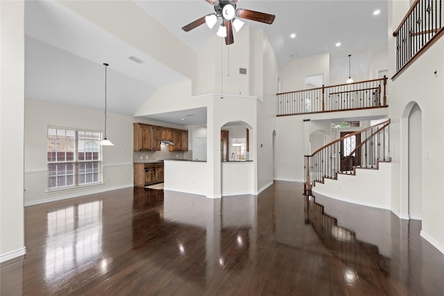 living room with ceiling fan, dark wood-type flooring, and high vaulted ceiling