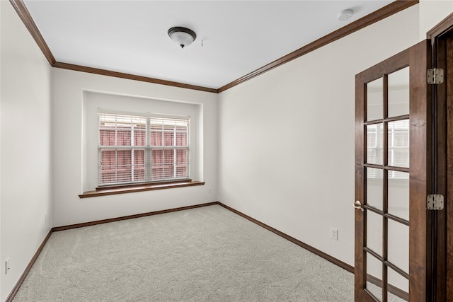 carpeted empty room featuring crown molding