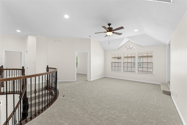 interior space featuring light carpet and vaulted ceiling