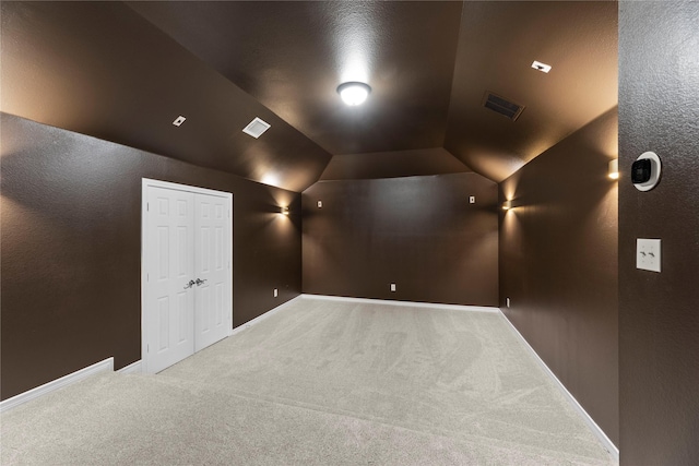 cinema room featuring carpet and lofted ceiling