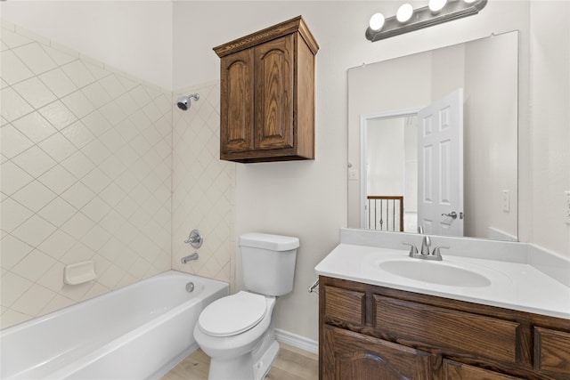 full bathroom with vanity, tiled shower / bath combo, and toilet