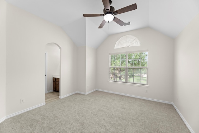 carpeted spare room with ceiling fan and lofted ceiling