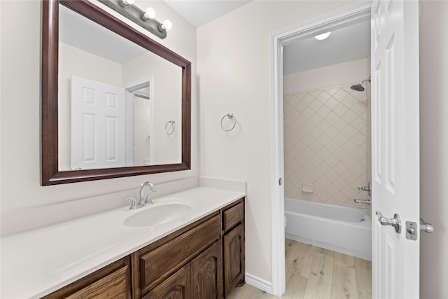 full bathroom featuring vanity, toilet, wood-type flooring, and tiled shower / bath