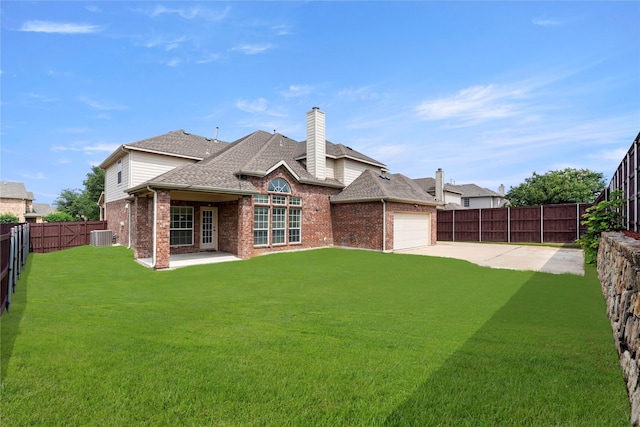 rear view of house with central AC, a yard, a patio, and a garage