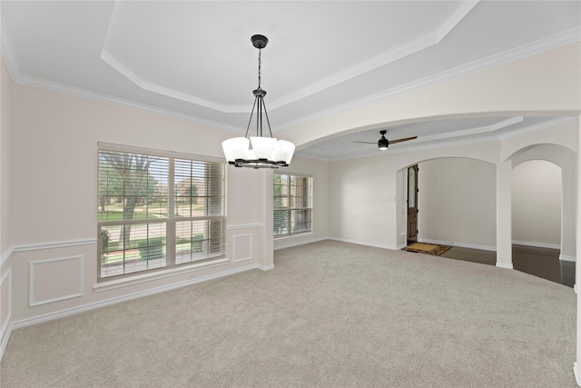 unfurnished room with a tray ceiling, light carpet, crown molding, and ceiling fan with notable chandelier