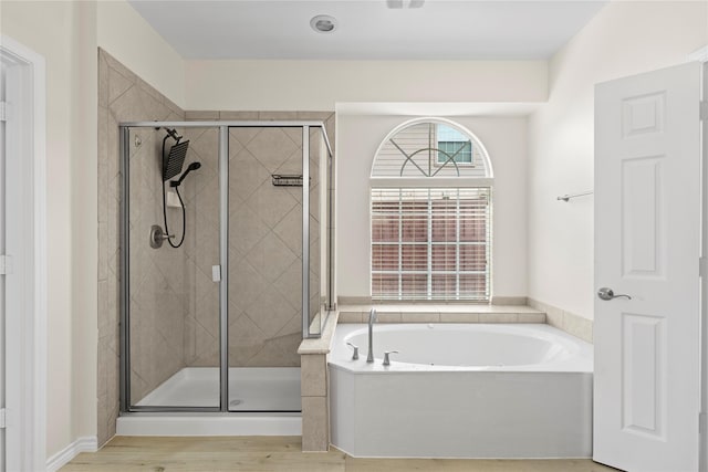 bathroom featuring hardwood / wood-style flooring and independent shower and bath