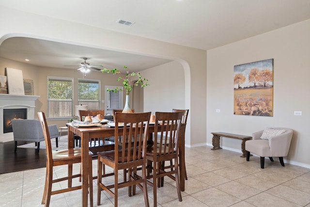 tiled dining room featuring ceiling fan