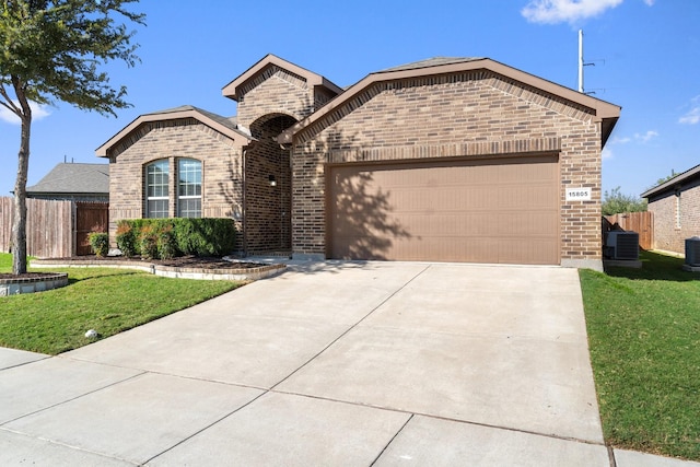 view of front of property featuring a front lawn, central AC unit, and a garage