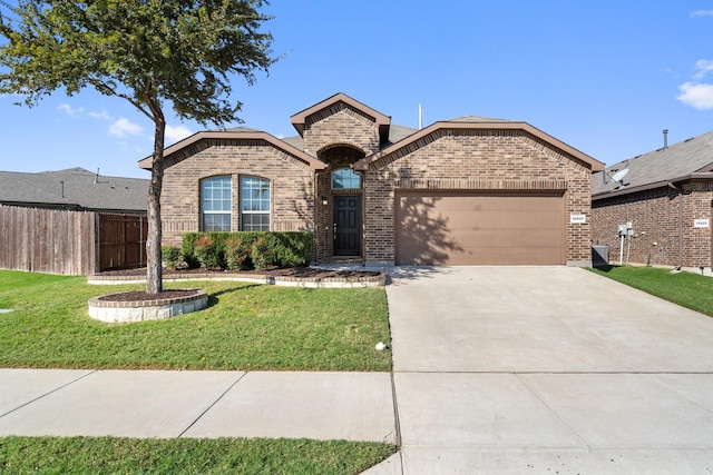 view of front of property featuring a garage and a front lawn