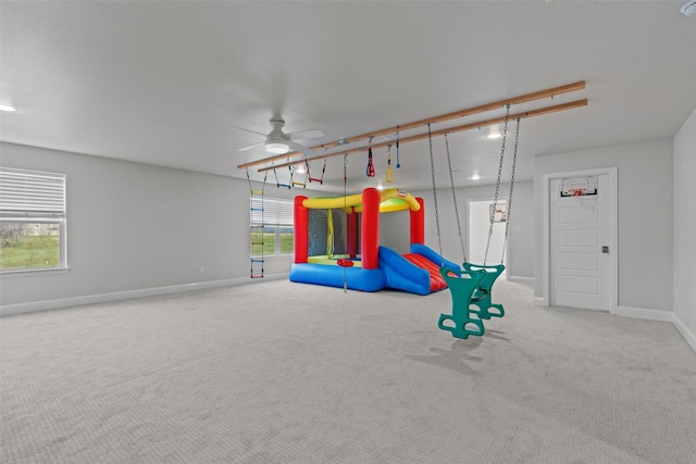 rec room with carpet flooring and ceiling fan