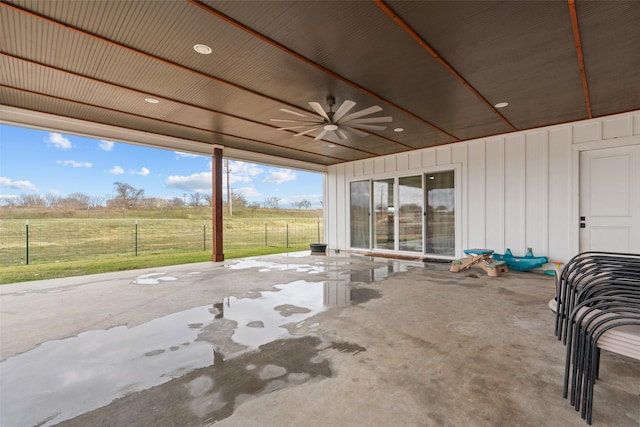 view of patio with ceiling fan and a rural view