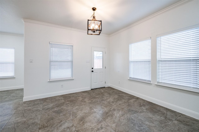 entrance foyer featuring crown molding and a chandelier