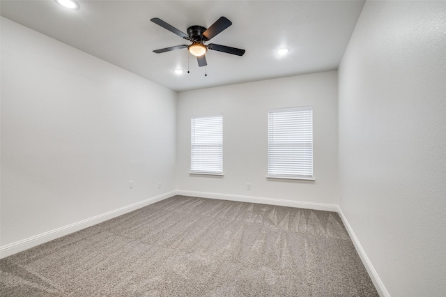 spare room with carpet flooring and ceiling fan