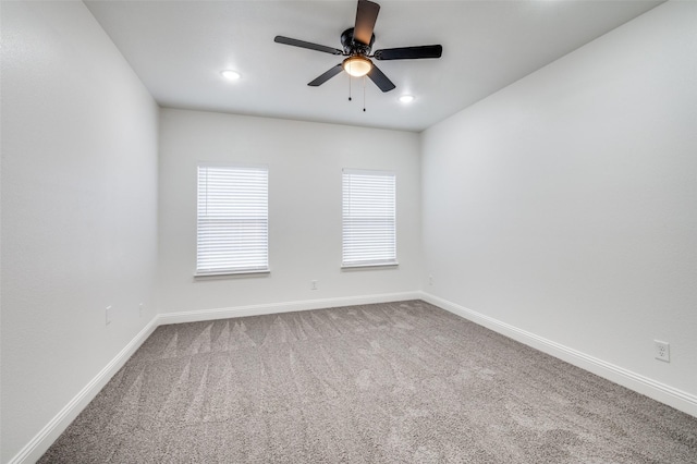 spare room with carpet and ceiling fan