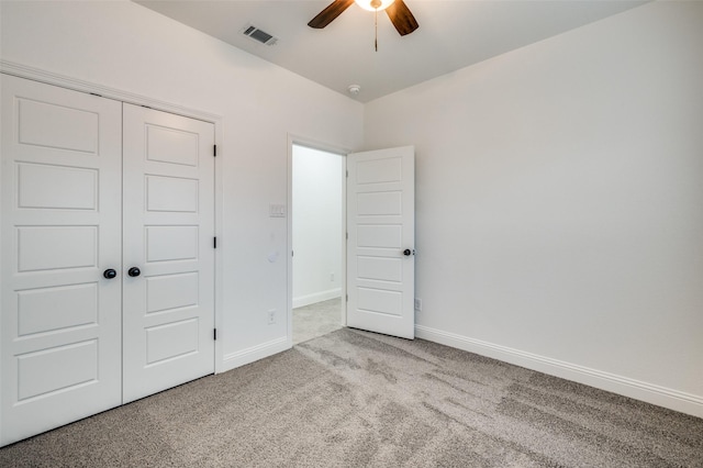 unfurnished bedroom with light carpet, ceiling fan, and a closet